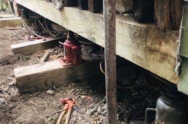 A house with tools on its wooden floor.