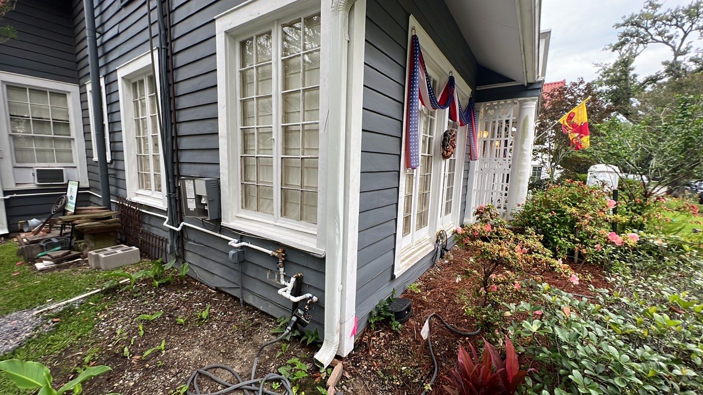 A house with a flag on the front porch, showcasing its elevation.