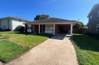A house in a neighborhood with a driveway.