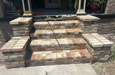 A set of brick steps leading to a front door with Foundation Repair.