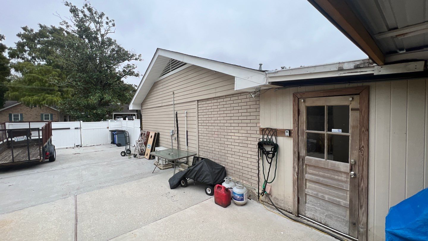 A small backyard with a shed and a garage.