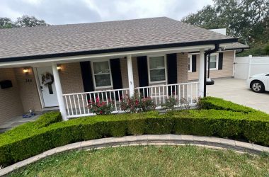 A house with a car parked in front of it.