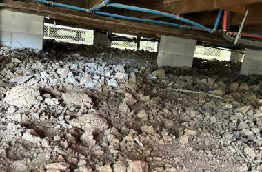 A large pile of dirt under a building.