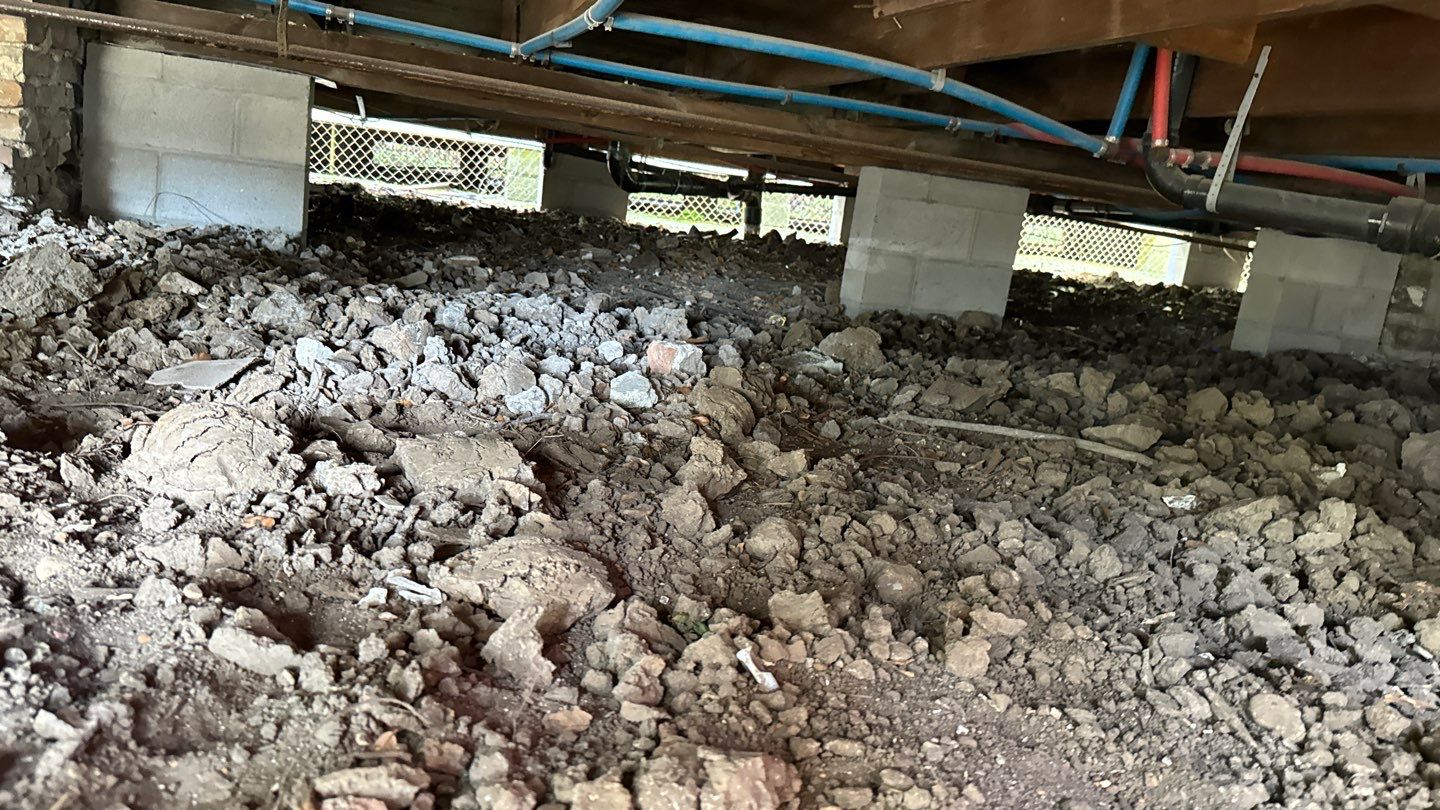 A large pile of dirt under a building.