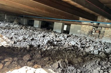 A room with a lot of dirt and rocks in it.