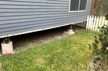 A house with a white picket in front of it.