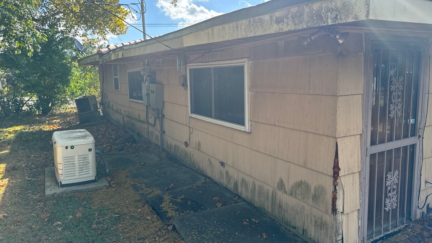 A house with an air conditioner on the side of it.