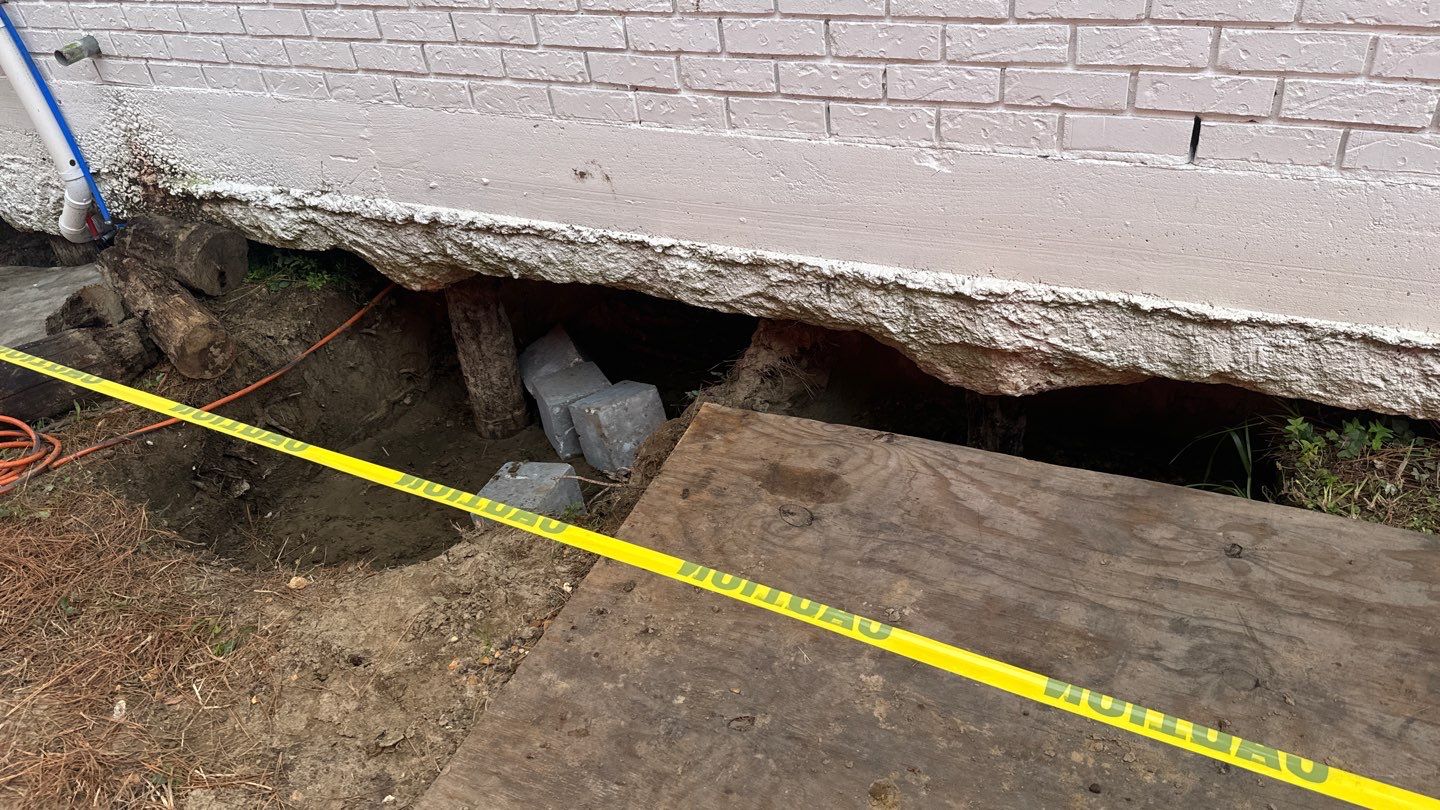 A hole in the ground next to a yellow tape.