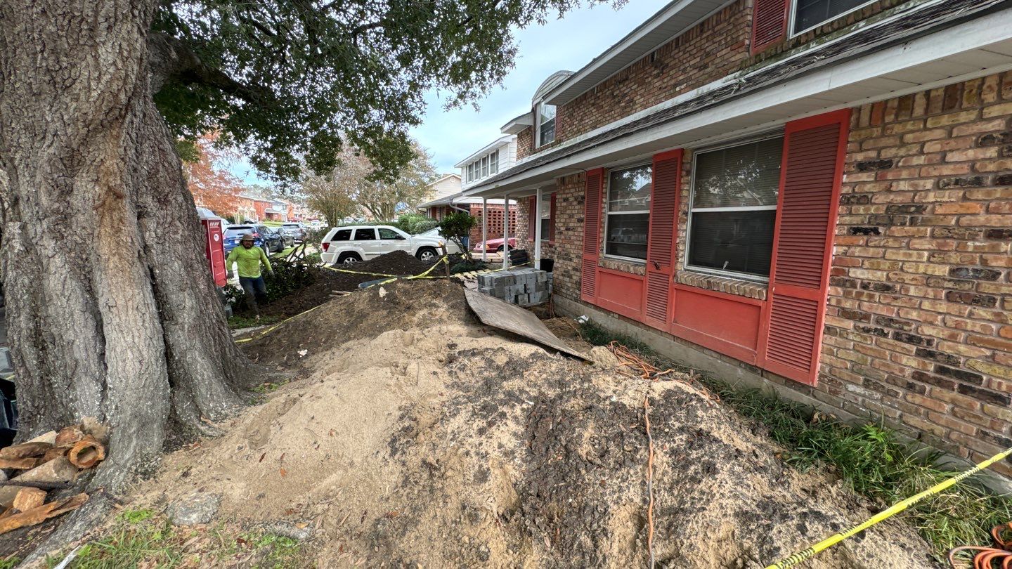 A pile of dirt in front of a house.