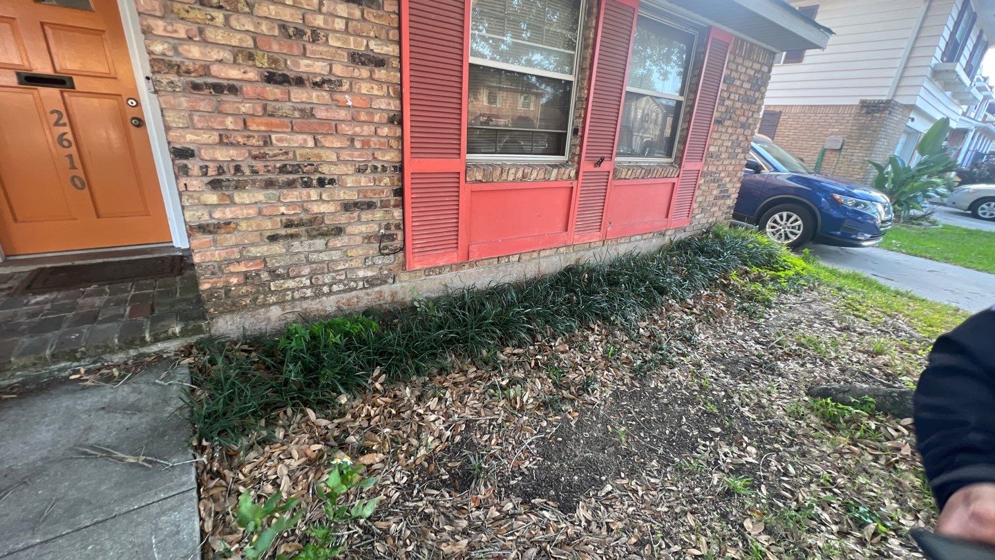 A man standing in front of a house.