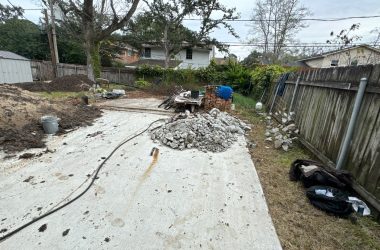 A backyard is being worked on by a construction crew.